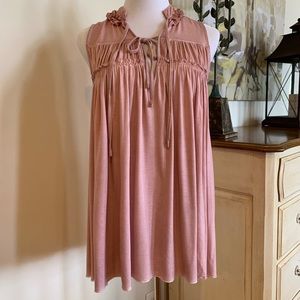 Pretty pink stone washed top with ruched details.